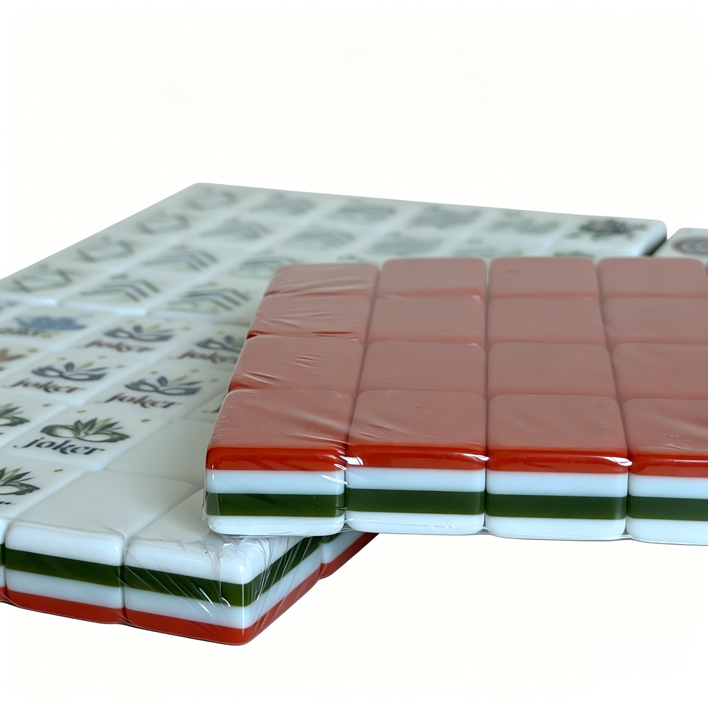 Close-up of The Coral Reef American Mahjong Set by USA Mahjong Co., featuring 166 vibrant coral red acrylic tiles with elegant gold inlays.
