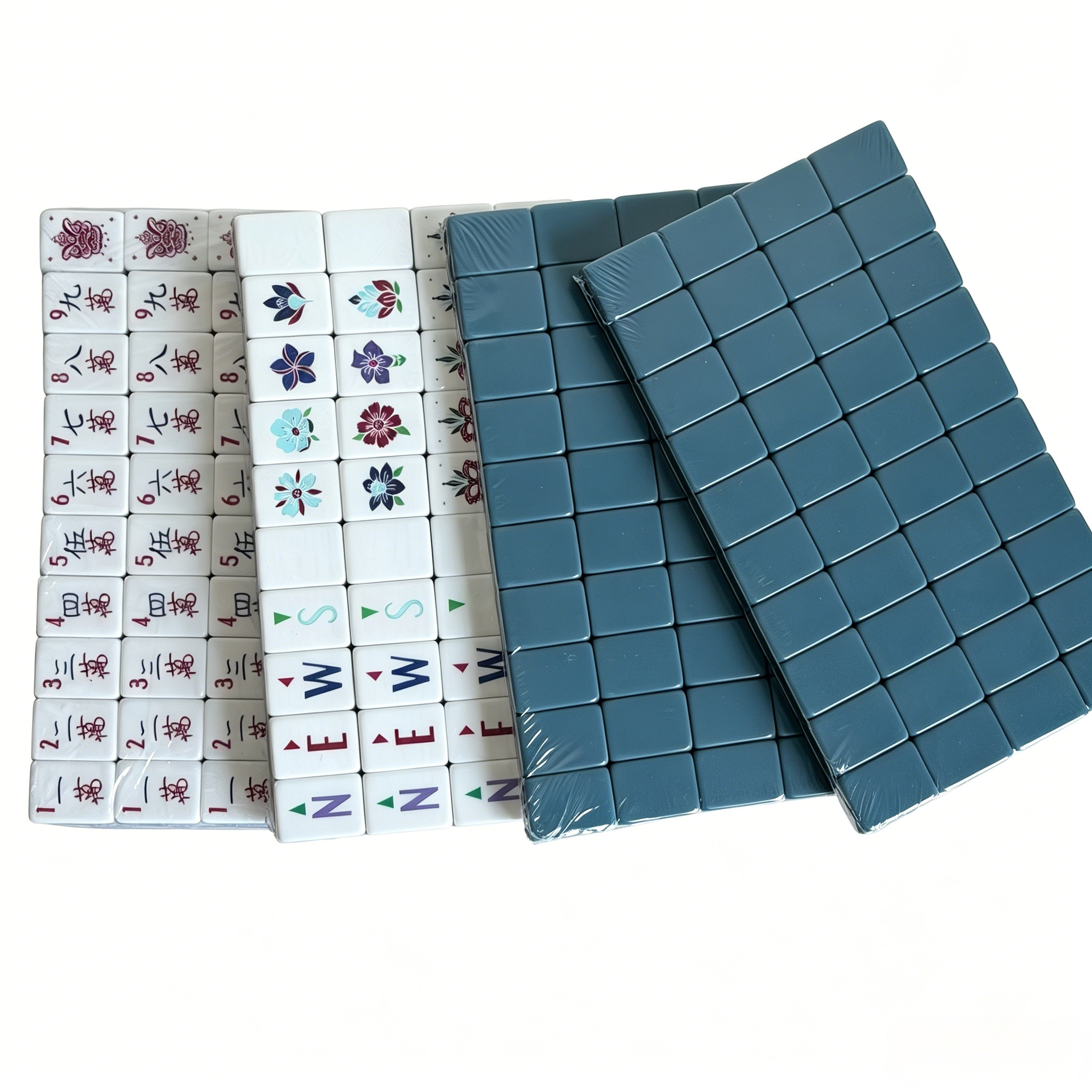 Close-up of Slate Compass American Mahjong Set by USA Mahjong Co. featuring 166 blue-grey acrylic tiles with gold inlays.