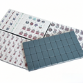 Modern American Mahjong Set by USA Mahjong Co. featuring 166 weighted acrylic tiles with deep petrol backs and intricate tile designs.